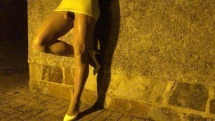 Night time whore hanging around in public in mini skirt .