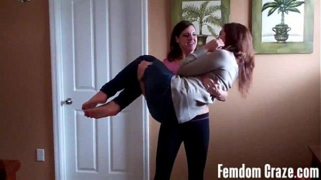 Fit babes Cherry and Sarah lifting each other up